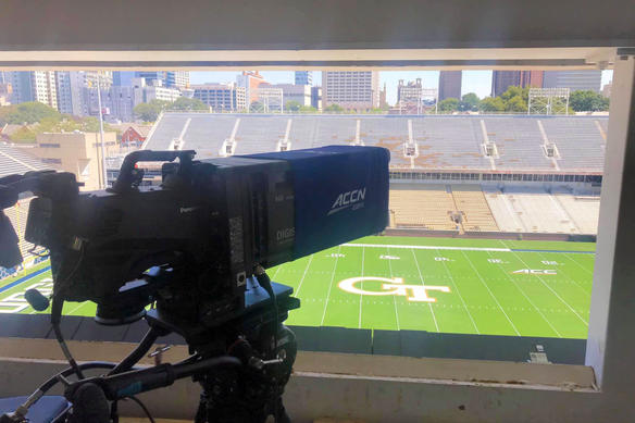 professional broadcasting camera capturing a college football game