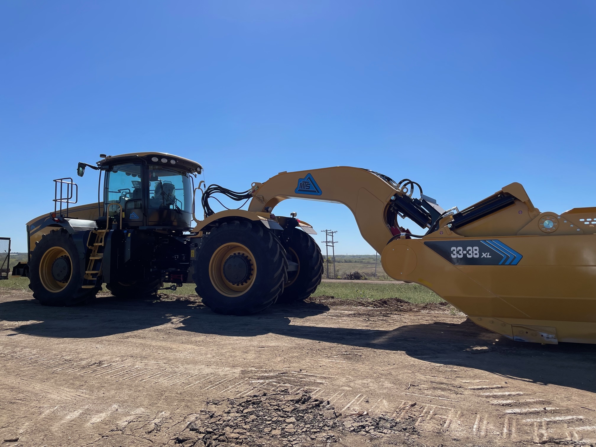 An excavator breaks ground at the site of the new EV battery facility in De Soto, Kansas