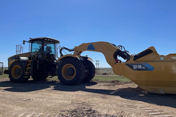 An excavator breaks ground at the site of the new EV battery facility in De Soto, Kansas