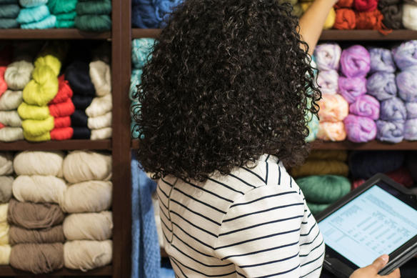 woman using a tablet in retail store