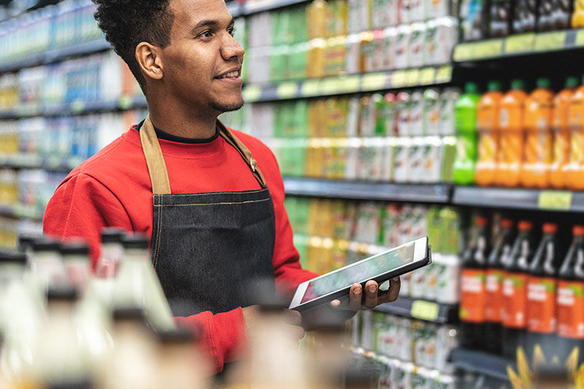 grocery store employee stocking shelves