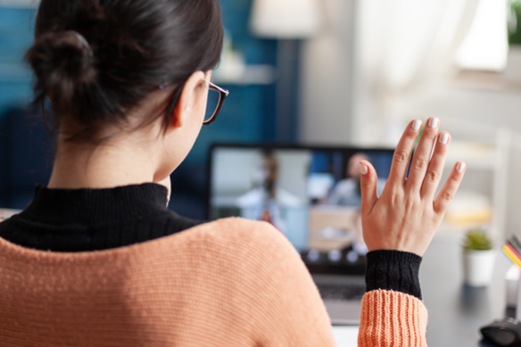 student raising hand in remote lecture